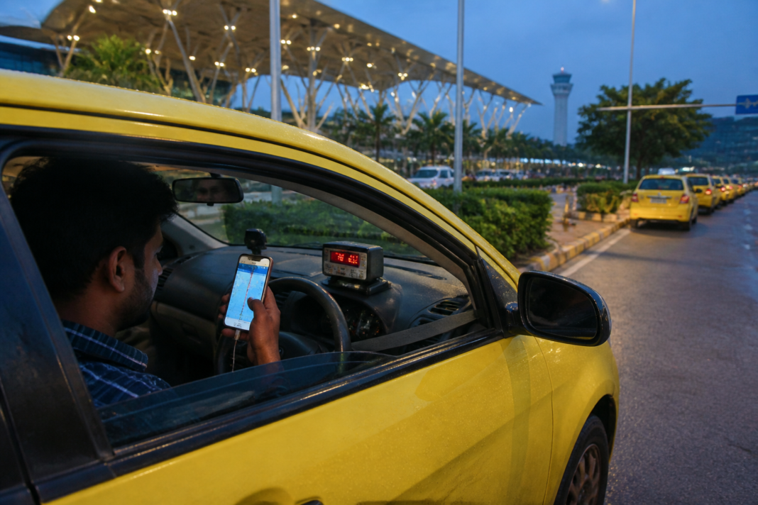 Bengaluru taxi fares displayed beside a digital meter and app booking screen