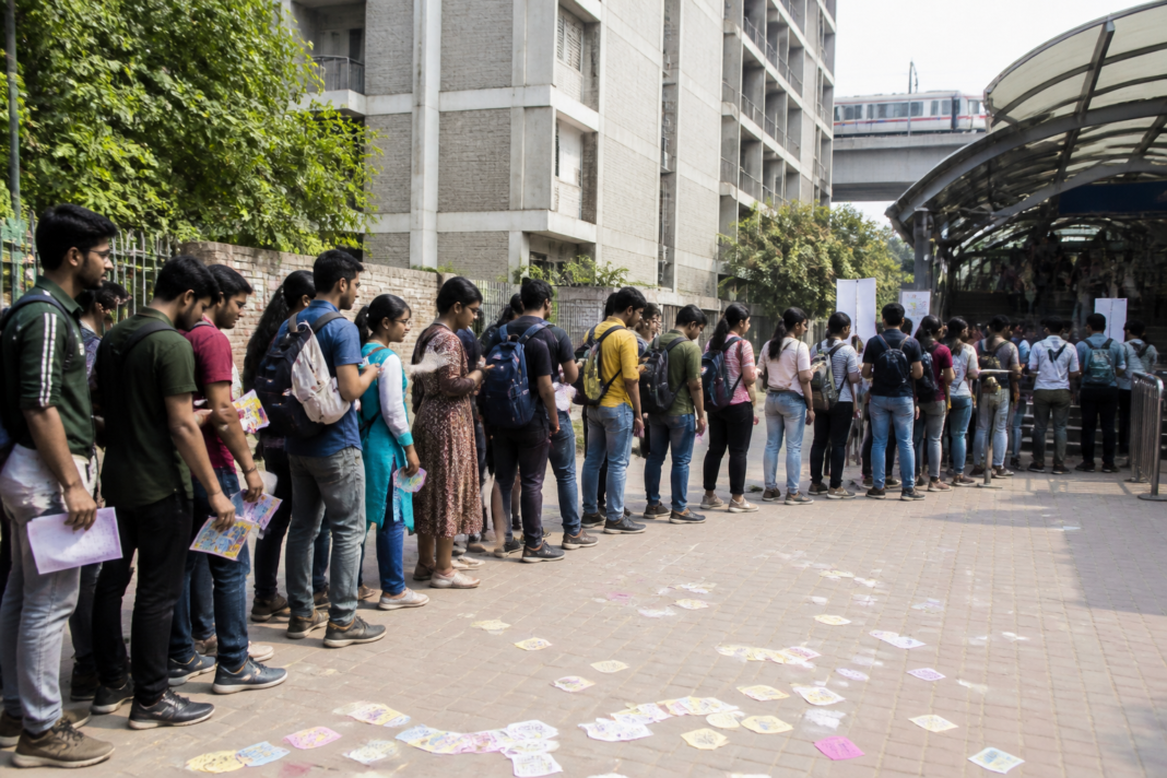 DUSU elections at a Delhi University campus with students queuing near election posters