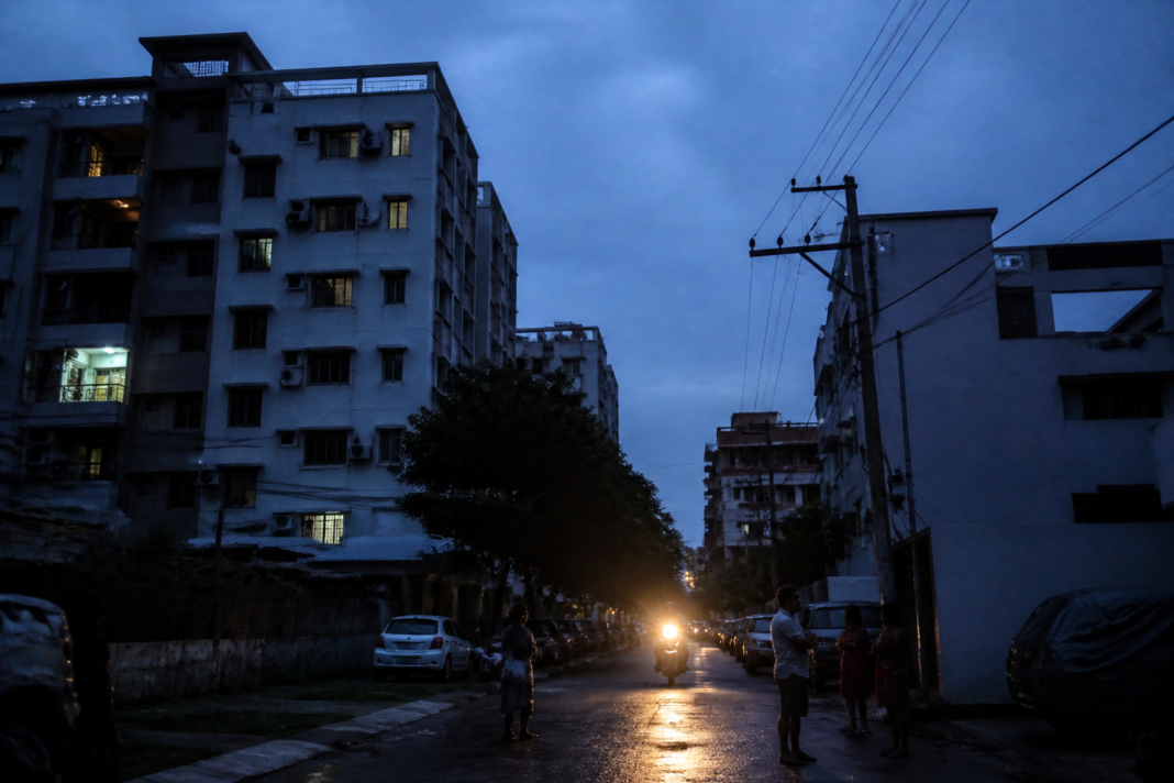 Hyderabad power cuts affecting a residential street with darkened buildings and utility lines