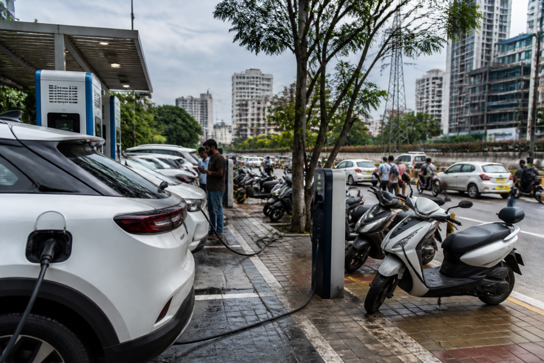 Karnataka EV infrastructure with electric vehicles charging at a Bengaluru station