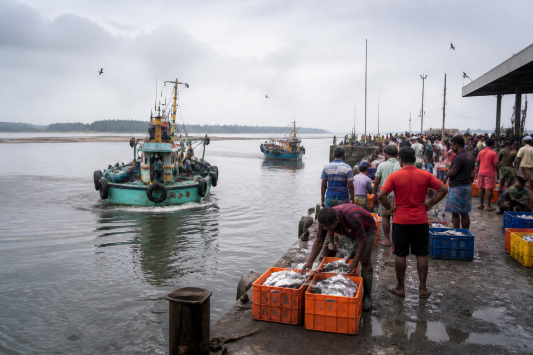 Mangaluru fishing harbour with boats and fishermen near the silted river mouth