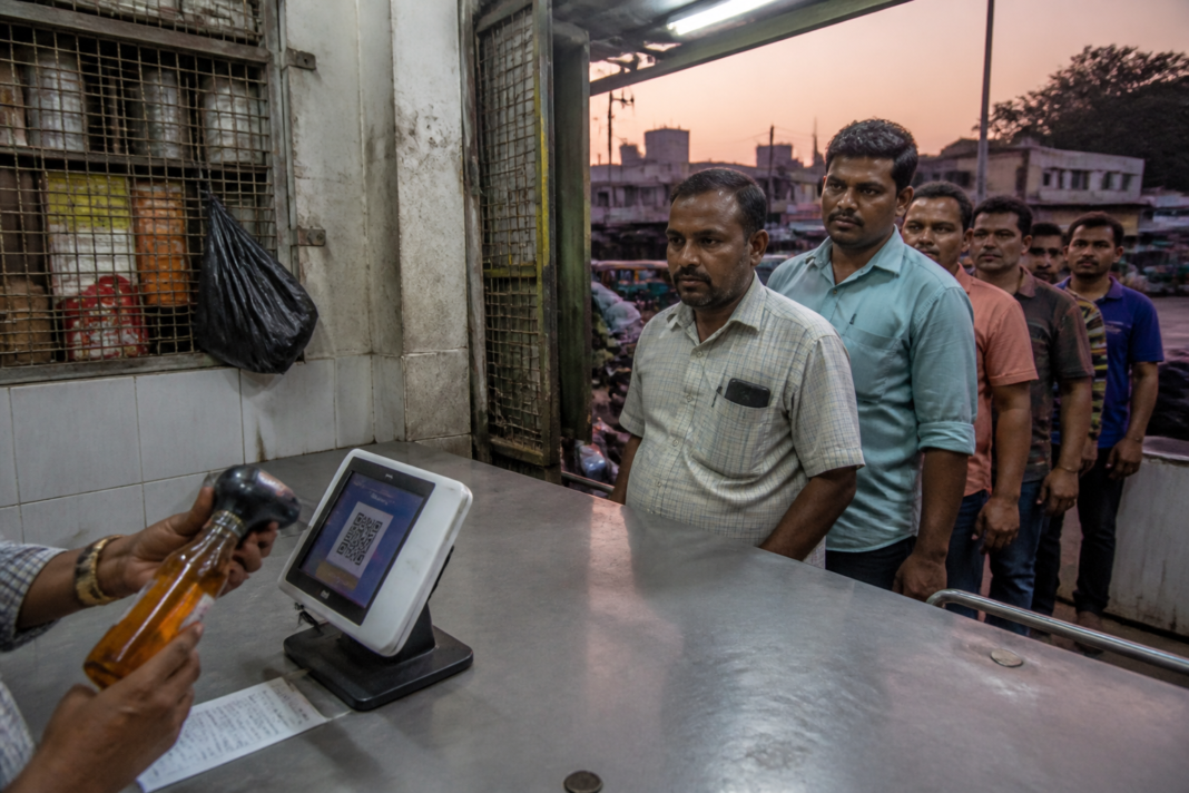 TASMAC digital payments at a Tamil Nadu liquor store counter with a QR payment device