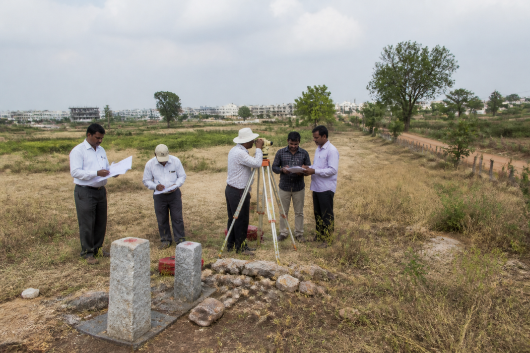 Telangana land dispute site near Hyderabad with boundary markers and surveyed agricultural land.