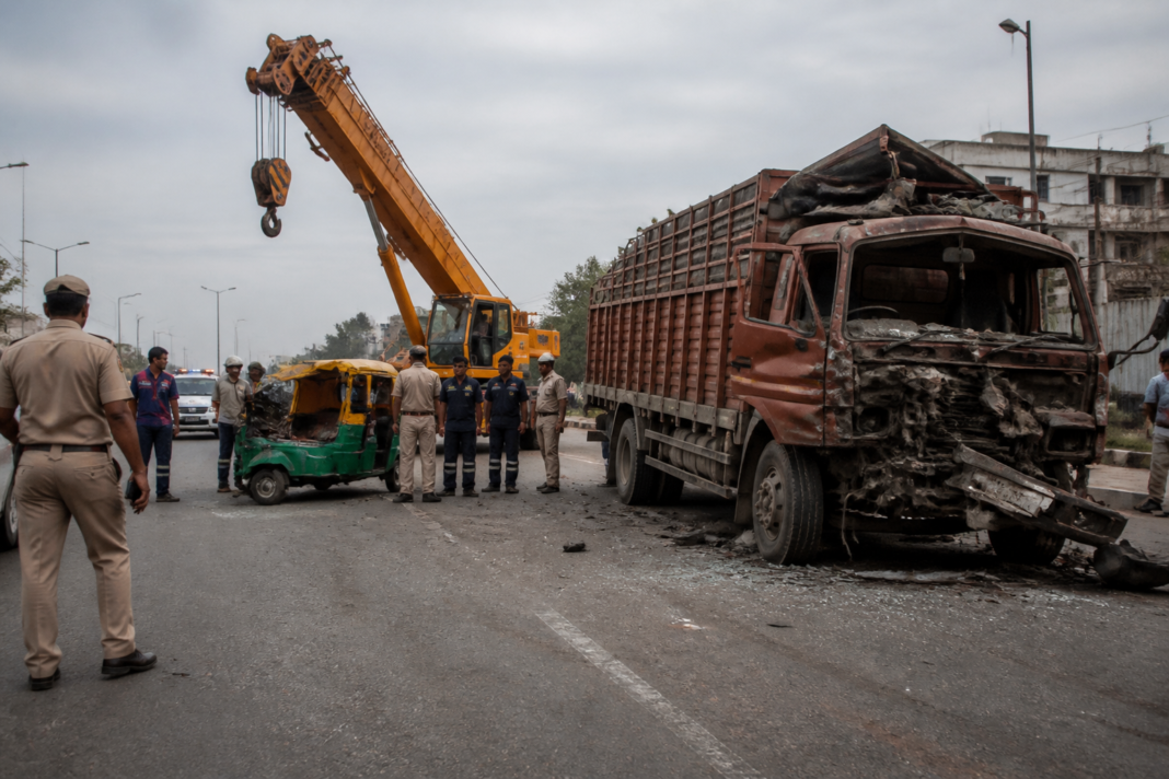 Sarita Vihar road accident scene involving a truck, crane and auto-rickshaw in Delhi