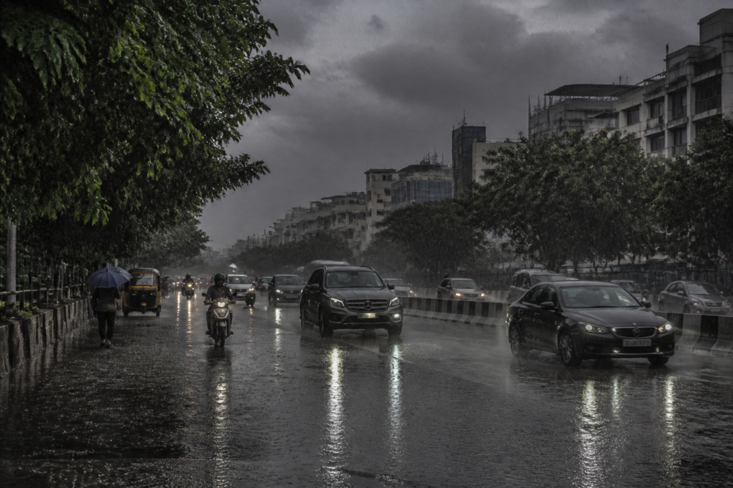 Telangana heavy rain over a Hyderabad street with dark clouds and wet roads