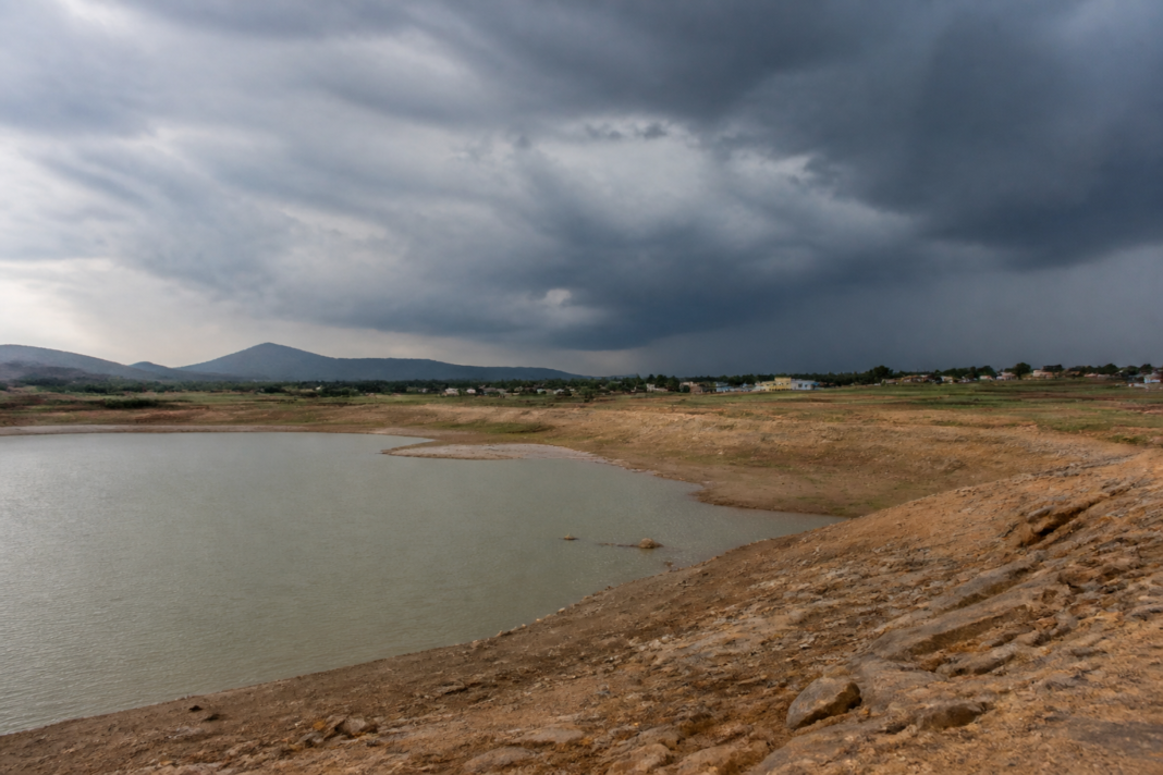 Andhra Pradesh rain forecast over a dry reservoir and parched agricultural landscape
