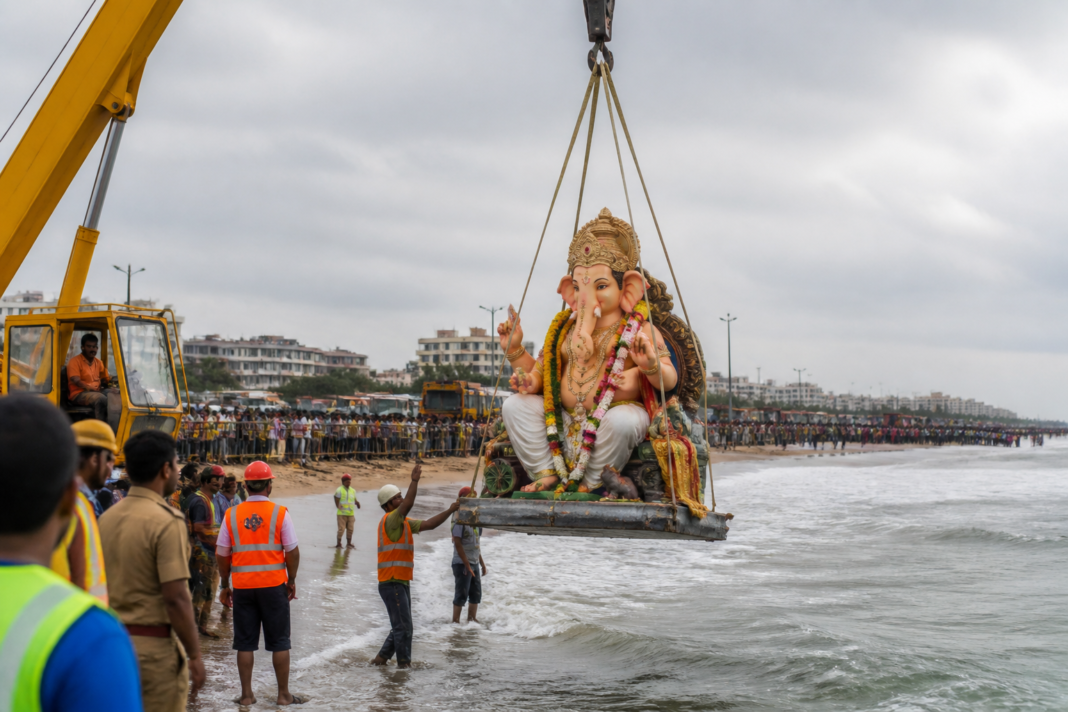 Ganesh idol immersion Tamil Nadu at a designated coastal site using a crane