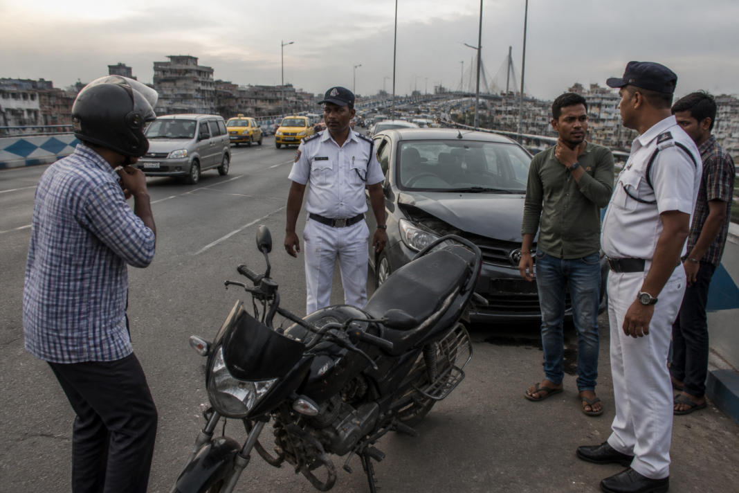 Kolkata manja accident scene on the Maa Flyover involving injured bikers and traffic police.