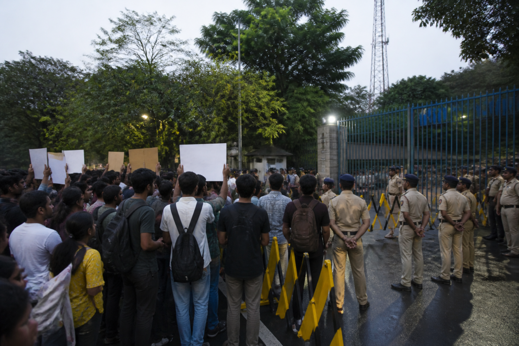 IIT Bombay campus protest after a student death, with police deployed near the Powai campus gates