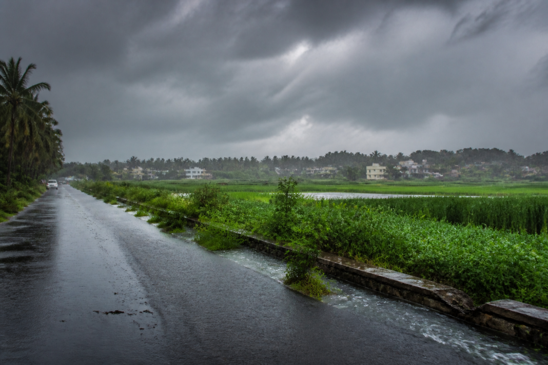 Karnataka rainfall over a rain-soaked rural road near Mandya