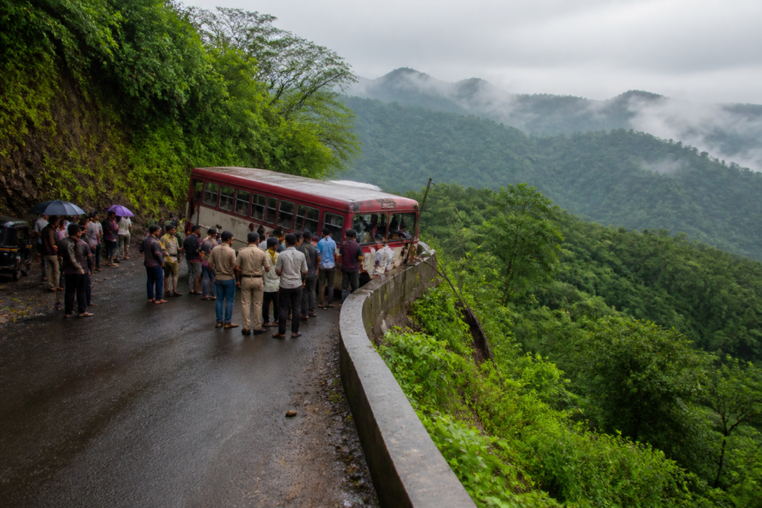 Shahapur ST bus accident site with a state transport bus stopped beside a roadside safety wall