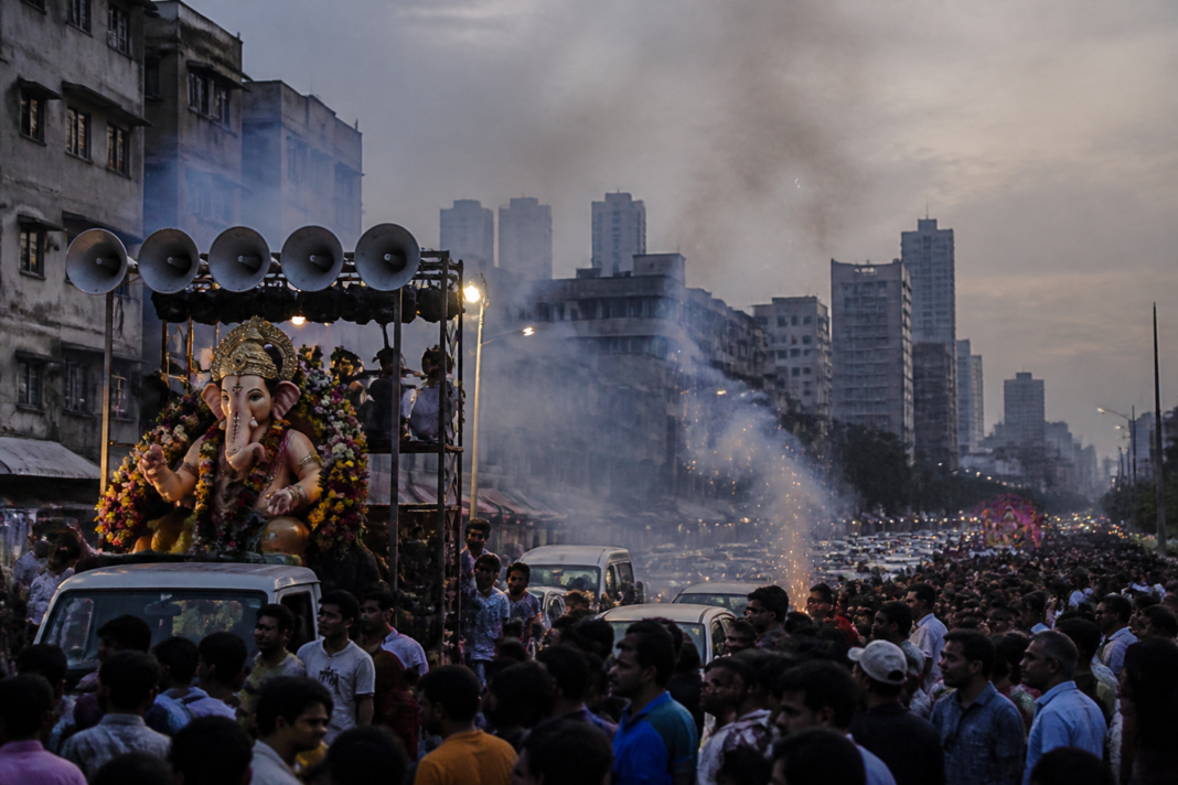 Mumbai Ganeshotsav procession with loudspeakers and firecrackers on a city road