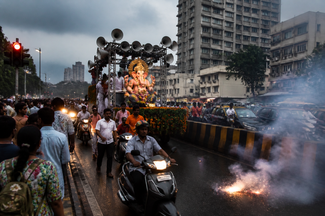 Mumbai Ganeshotsav procession with loudspeakers and firecrackers on a city road