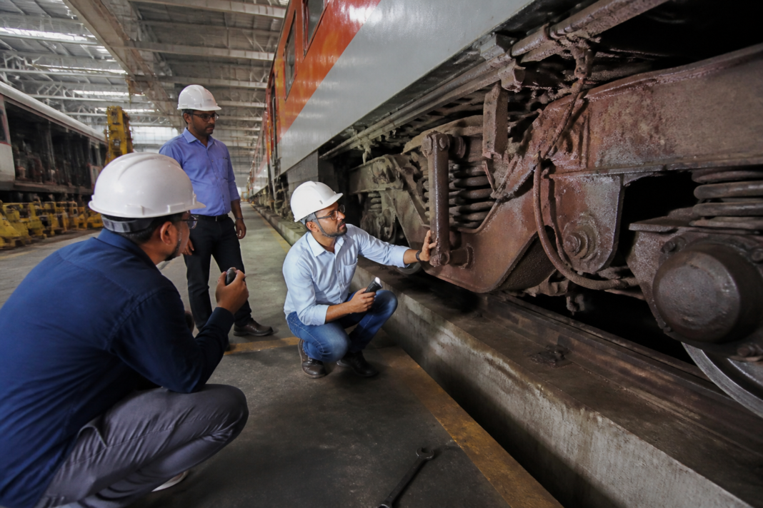 LHB train coach underframe inspected for corrosion during railway maintenance
