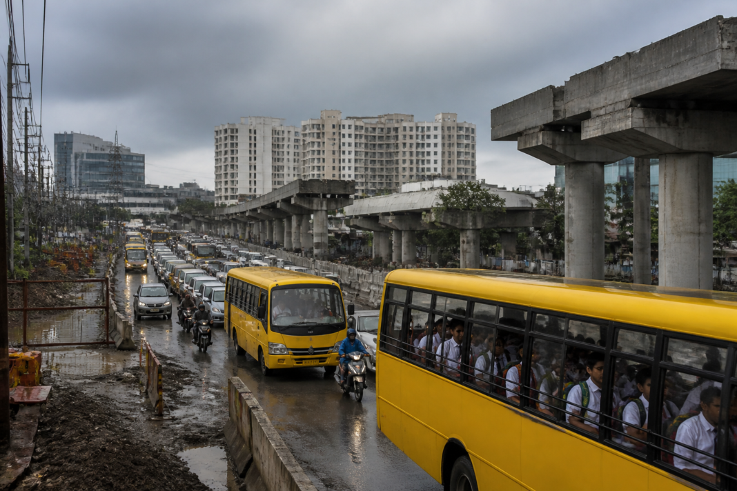 Bengaluru school bus traffic moving slowly through a congested Whitefield–Sarjapur road