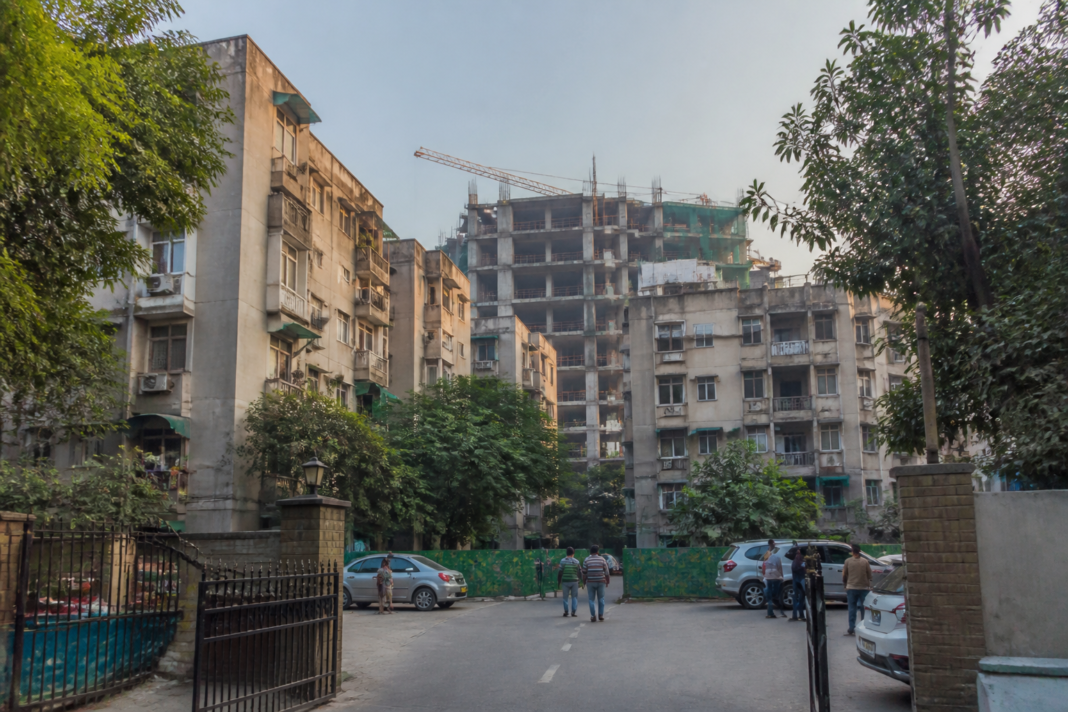 Delhi housing redevelopment site showing a cooperative housing complex and construction activity