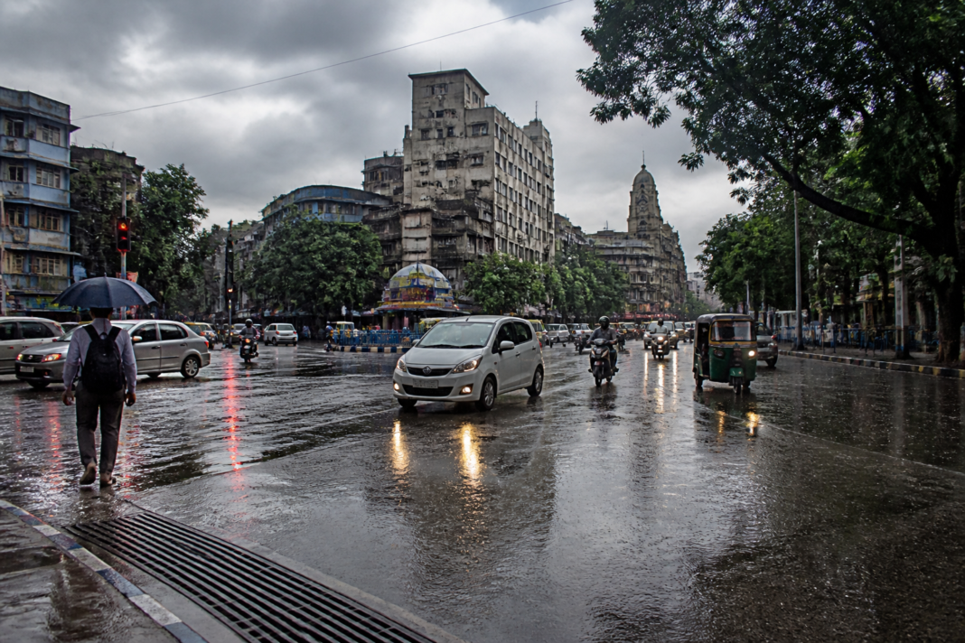 Kolkata rain forecast showing rain clouds over the city and wet streets during a weather system.