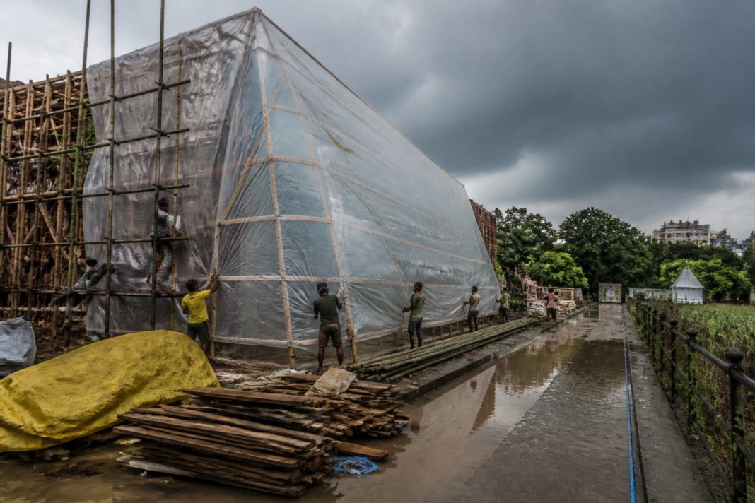 Kolkata Durga Puja pandal covered with protective sheets before forecast rain