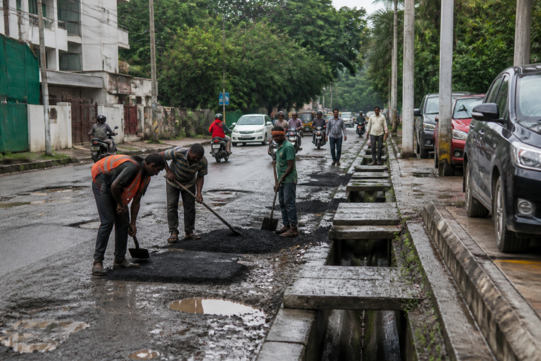 Vajarahalli 100 Ft Road repairs underway beside damaged footpaths and roadside drainage in Bengaluru