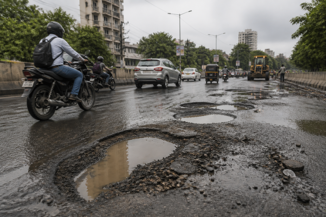 Pimpri Chinchwad potholes affecting a road near the Ganesh immersion procession route