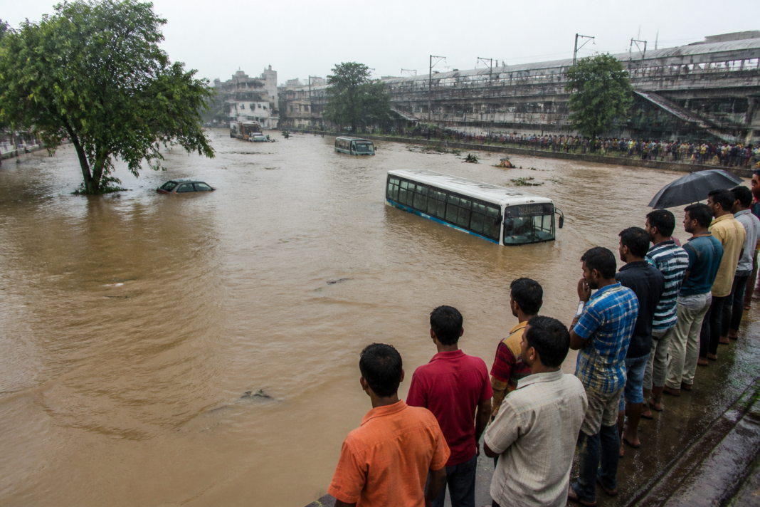 Andhra Pradesh heavy rains flooding a road near Rajahmundry with vehicles halted.
