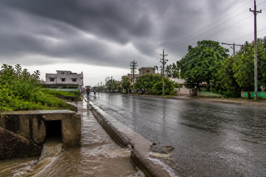 Heavy rain in Warangal with waterlogged roads and monsoon clouds over the city