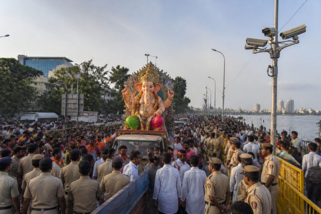 Hyderabad Ganesh immersion procession near Hussainsagar with police and surveillance cameras