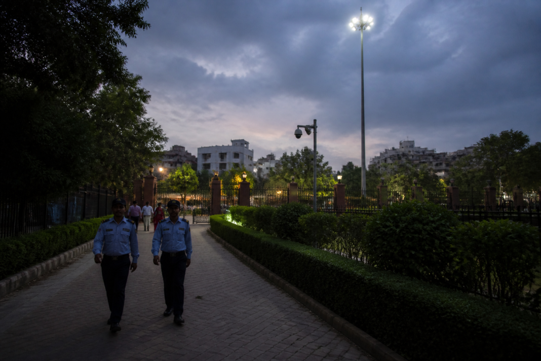 Delhi park safety audit showing a dimly lit green space with security patrols and boundary walls