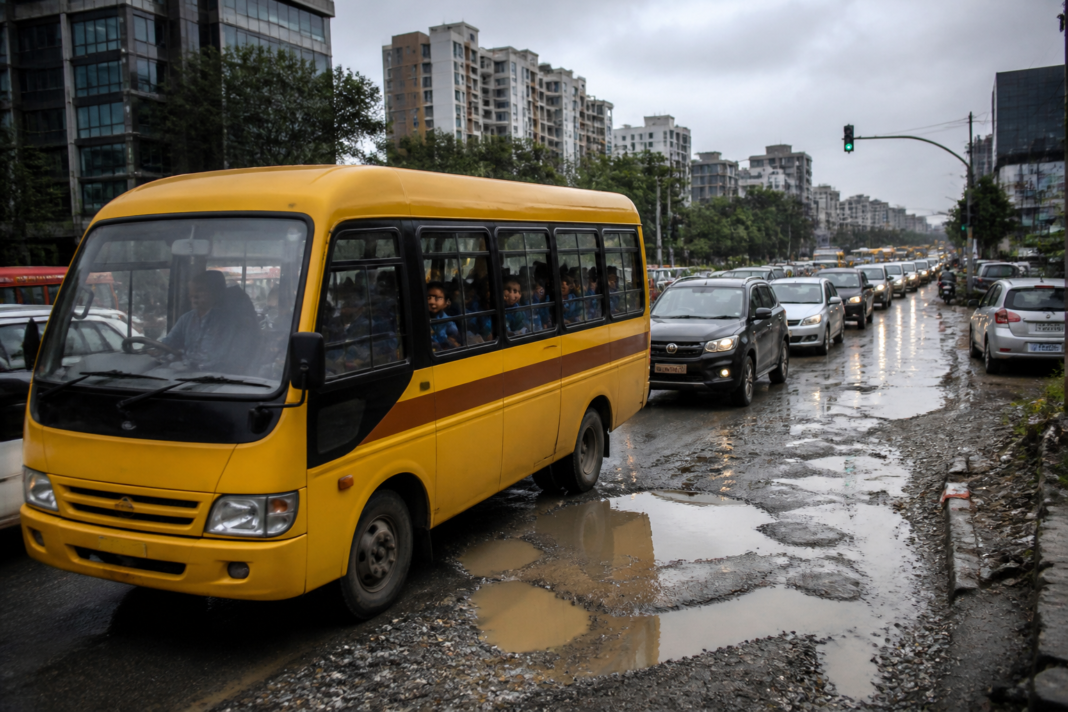 Bengaluru traffic surrounding a school bus on a congested eastern Bengaluru road
