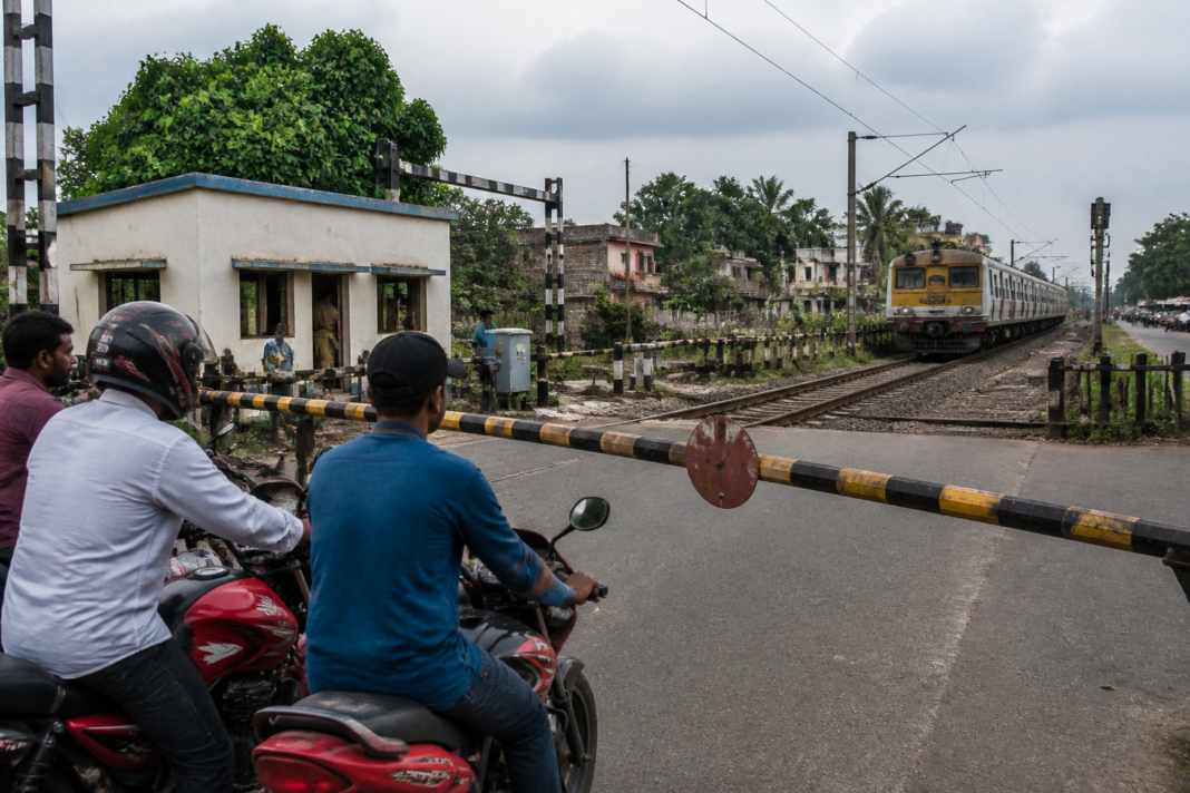 Murshidabad level crossing with railway gates and tracks under safety monitoring