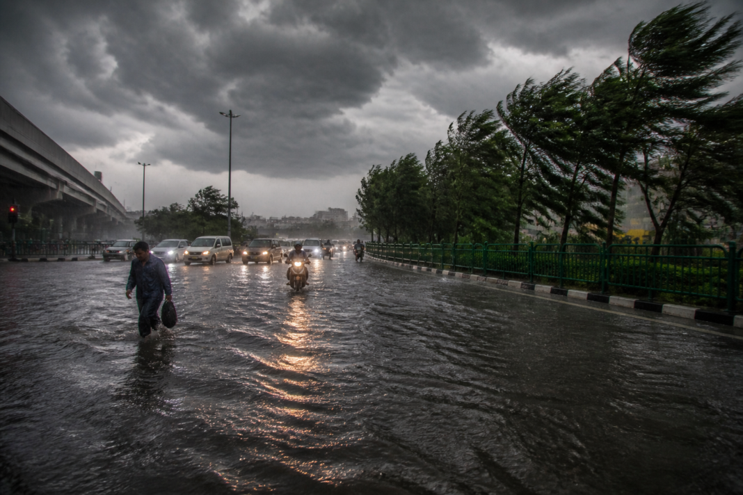 IMD weather forecast showing dark storm clouds over a rain-hit Indian city