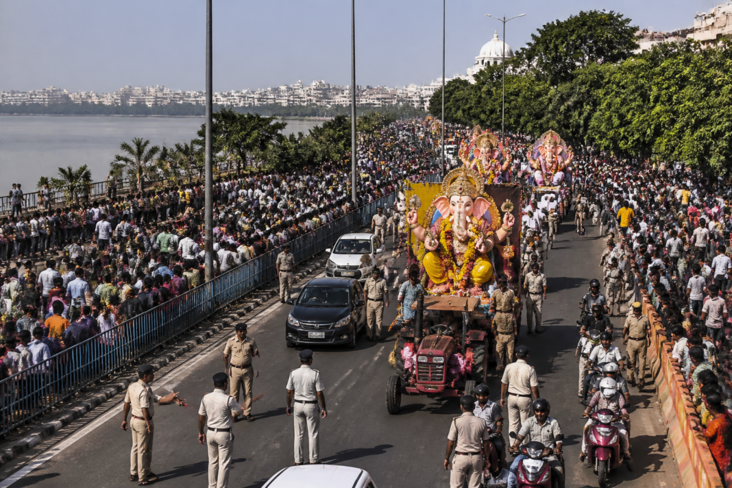 Hyderabad Ganesh immersion procession moving along a traffic-restricted city road
