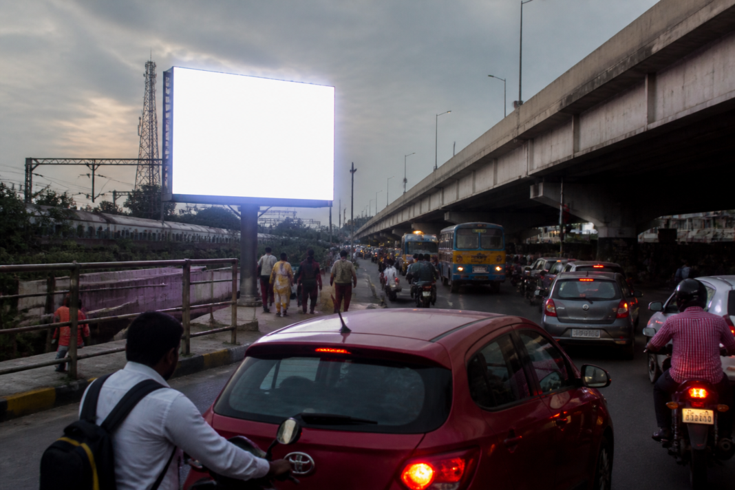 Tirusulam LED hoarding beside Chennai’s GST Road, where motorists face glare and traffic risks.