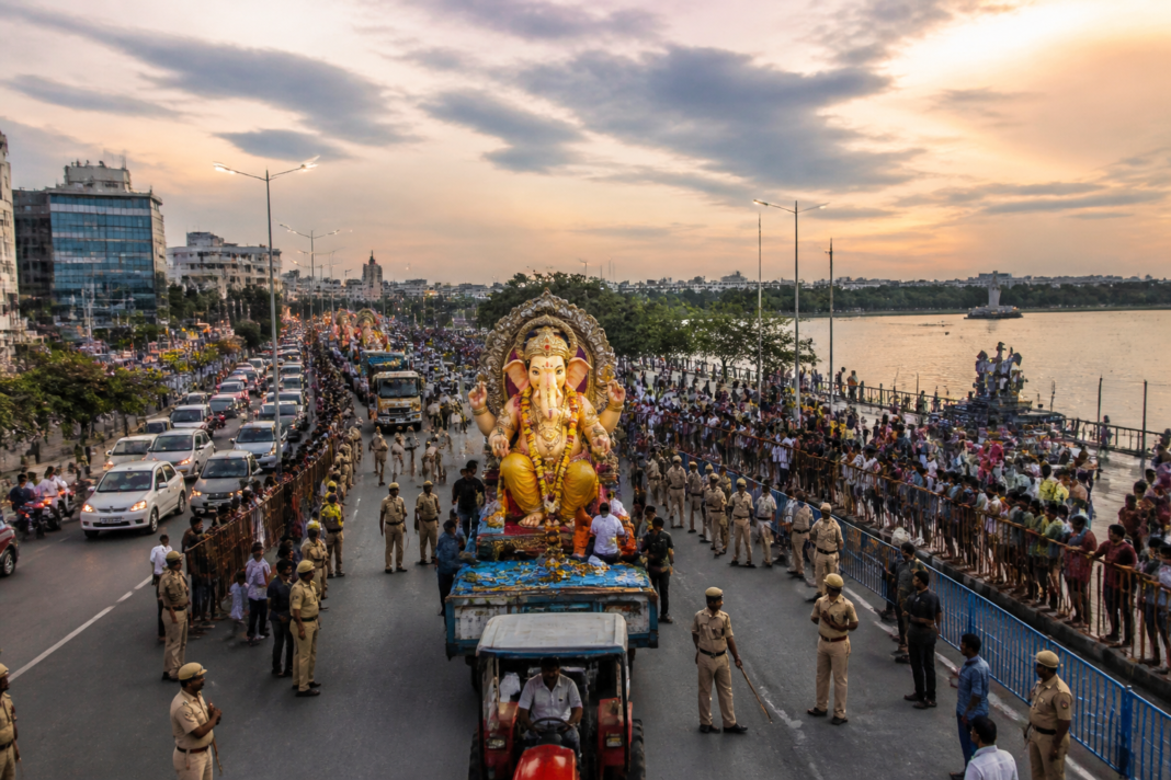 Hyderabad Ganesh immersion procession vehicles move towards Hussainsagar under police supervision.