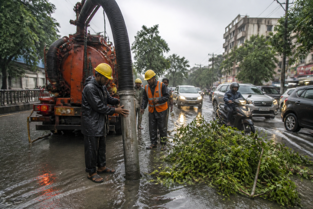 Patna rain affecting a city road as municipal workers clear storm-water drains