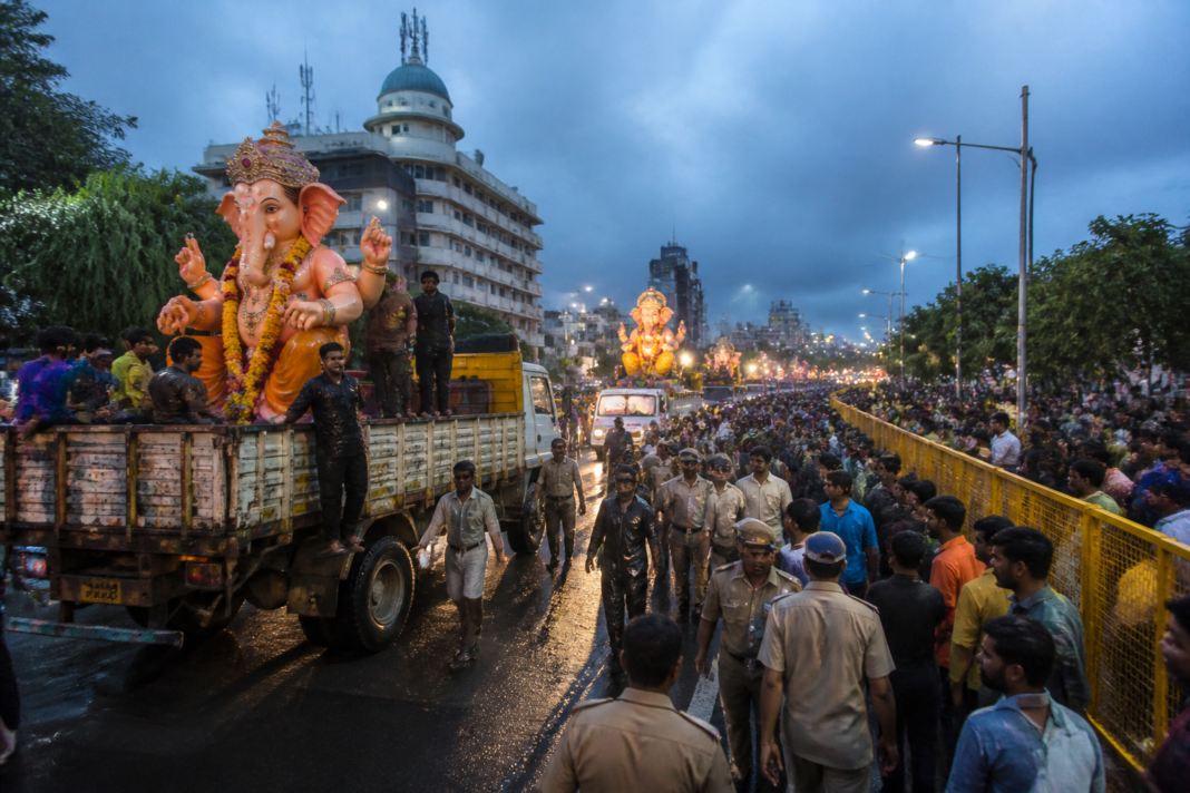 Hyderabad Ganesh immersion procession with police managing large crowds near Hussainsagar
