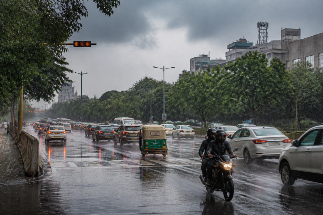 Delhi rain falling on a city road as temperatures drop under an IMD yellow alert