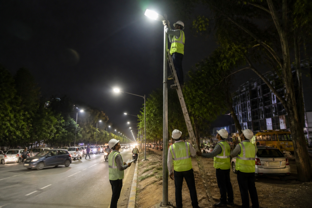 Bengaluru street light maintenance inspection on an urban road at night