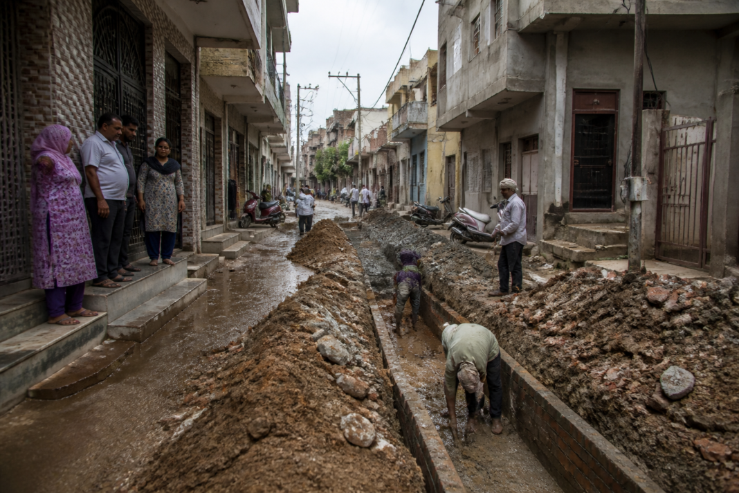 Delhi unauthorised colonies road and drainage infrastructure works in a dense residential neighbourhood