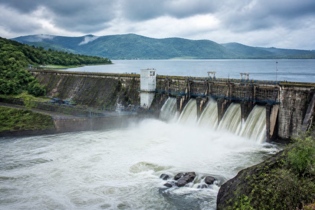 Karnataka reservoir water levels shown at a major dam with spillway and surrounding hills