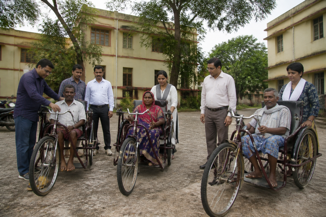 Latehar filariasis patients receiving mobility support outside a district government office