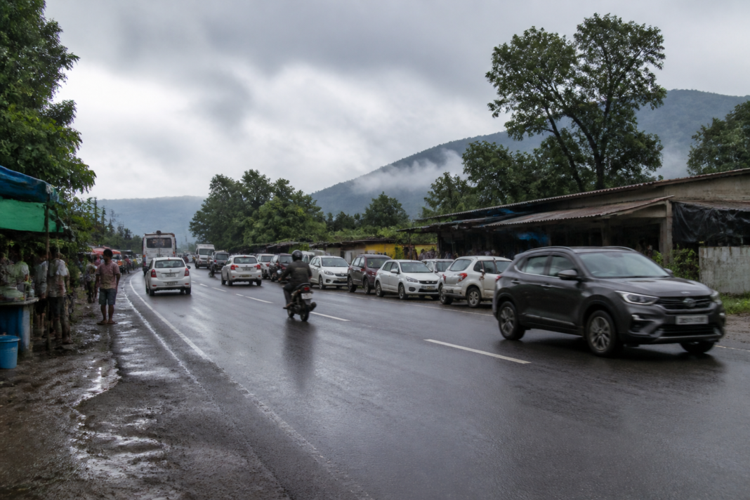 Badlapur-Karjat highway with roadside commercial structures and traffic