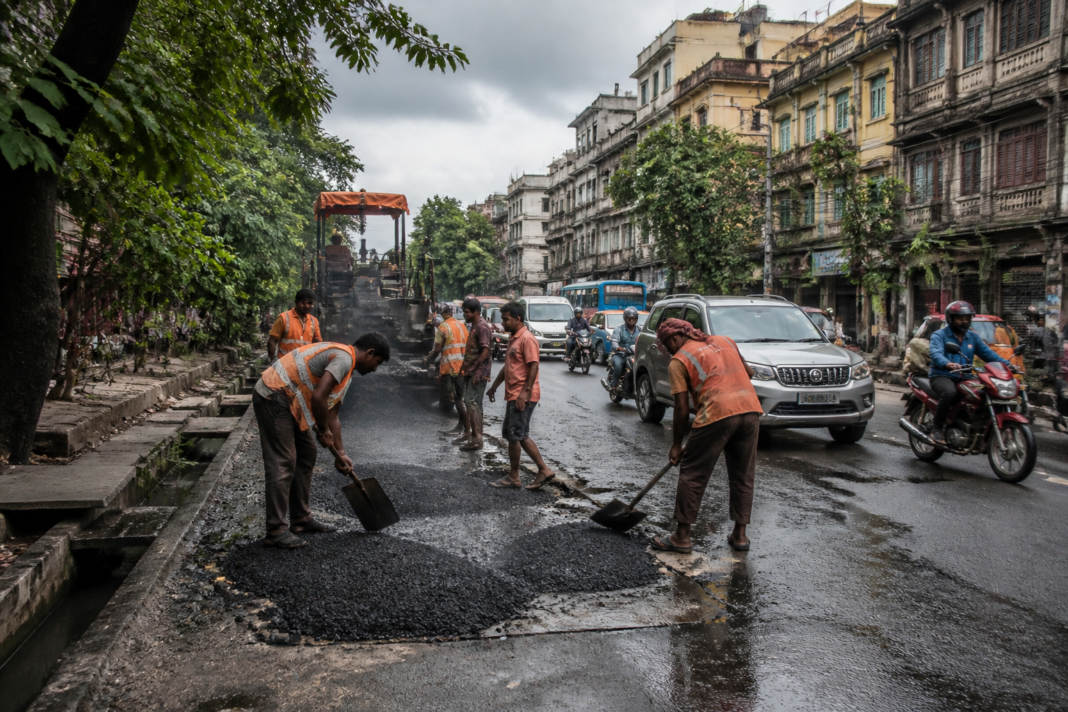 Kolkata road repairs underway on a pothole-damaged urban road