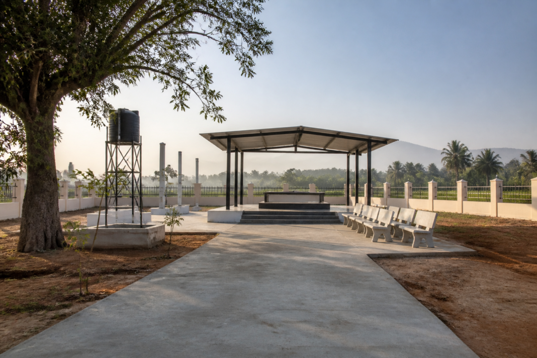 Hunsur cremation grounds with a covered ritual shelter and fenced public facility