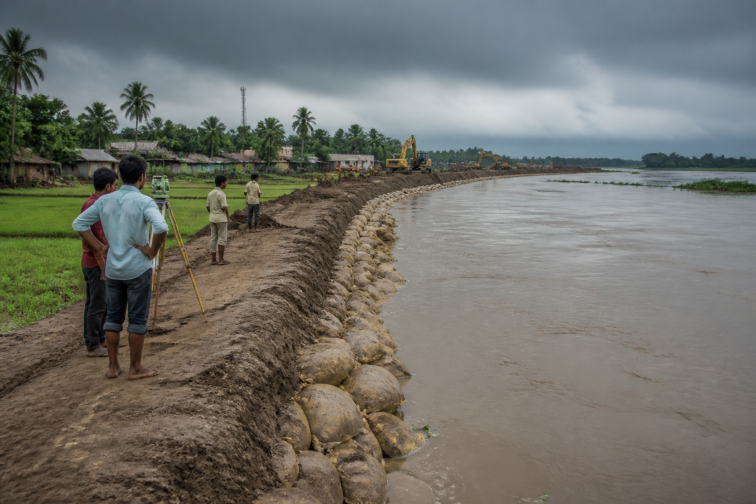Ghatal Master Plan flood-control work near a waterlogged settlement in West Bengal
