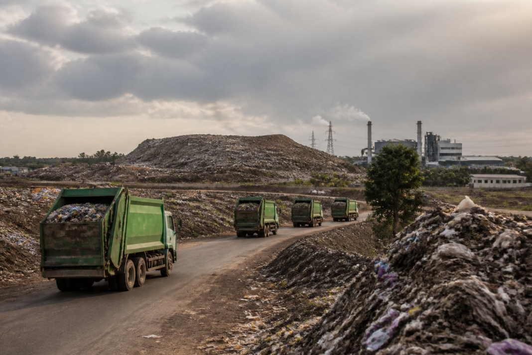 Coimbatore waste-to-energy plant site at Vellalore with municipal waste trucks