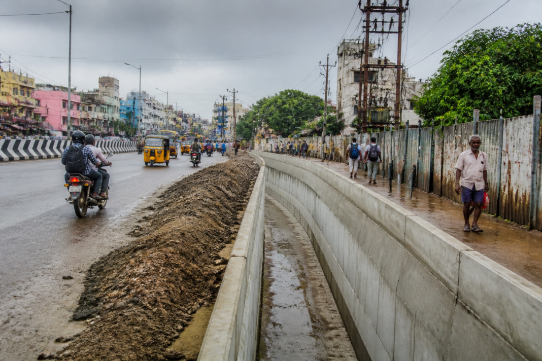 Perambur stormwater drain construction beside a Chennai road and pedestrian walkway