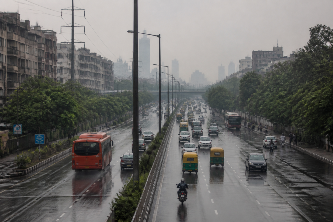 Delhi air pollution haze over a city road after monsoon rainfall