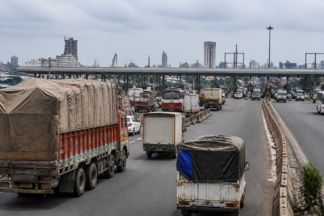 Mumbai toll hike at an entry point with commercial trucks approaching toll lanes