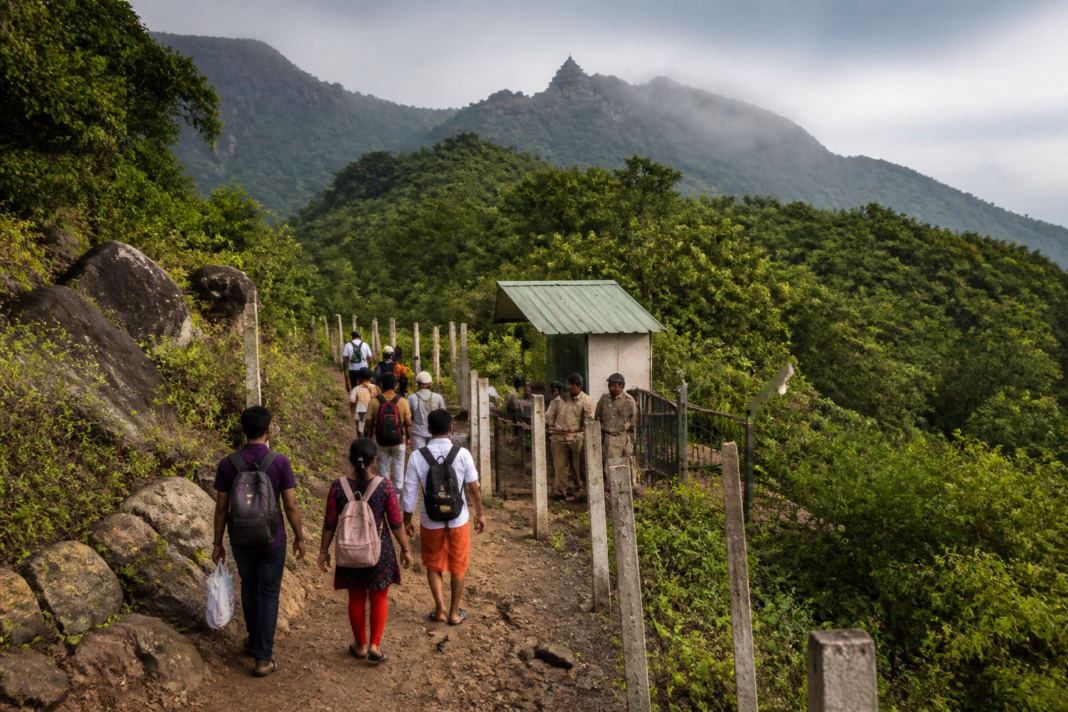Coimbatore temple visitors trekking through a forest route in the Western Ghats